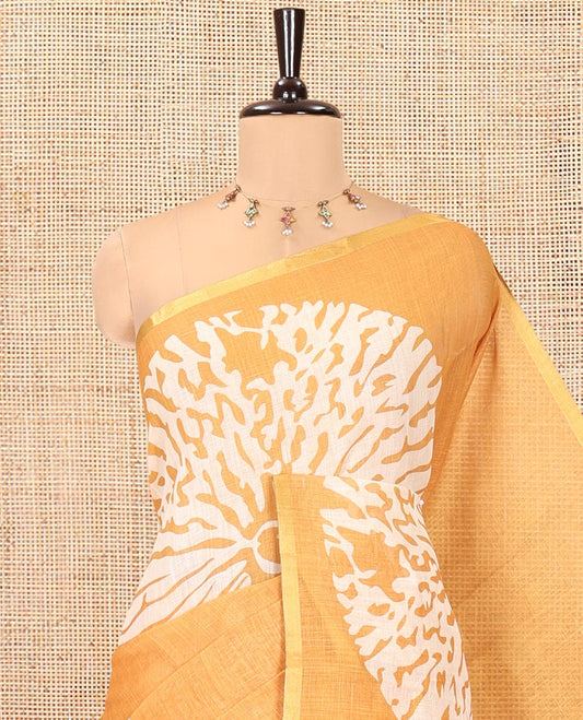 Mustard Linen Cotton Saree, Gleamed Up with Floral Motifs Printed on Its Body, Subtle Piping Border, Complemented by a Contrast Floral Printed Blouse, and Paired with a Contrast Blouse