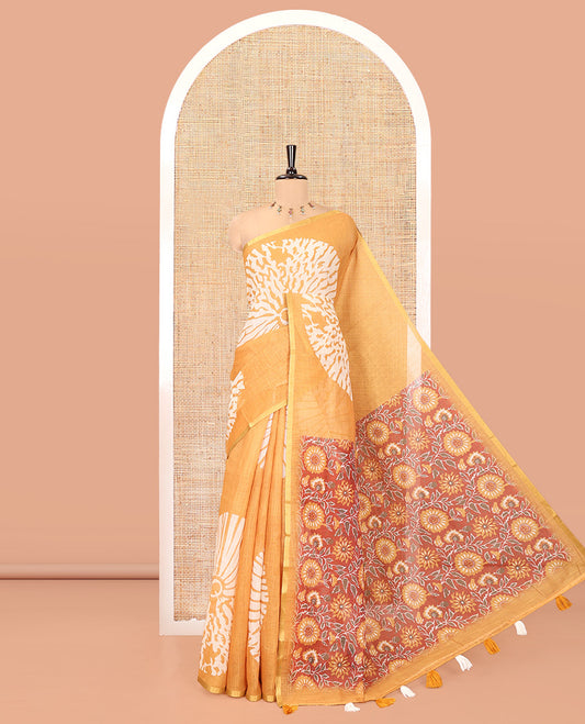 Mustard Linen Cotton Saree, Gleamed Up with Floral Motifs Printed on Its Body, Subtle Piping Border, Complemented by a Contrast Floral Printed Blouse, and Paired with a Contrast Blouse