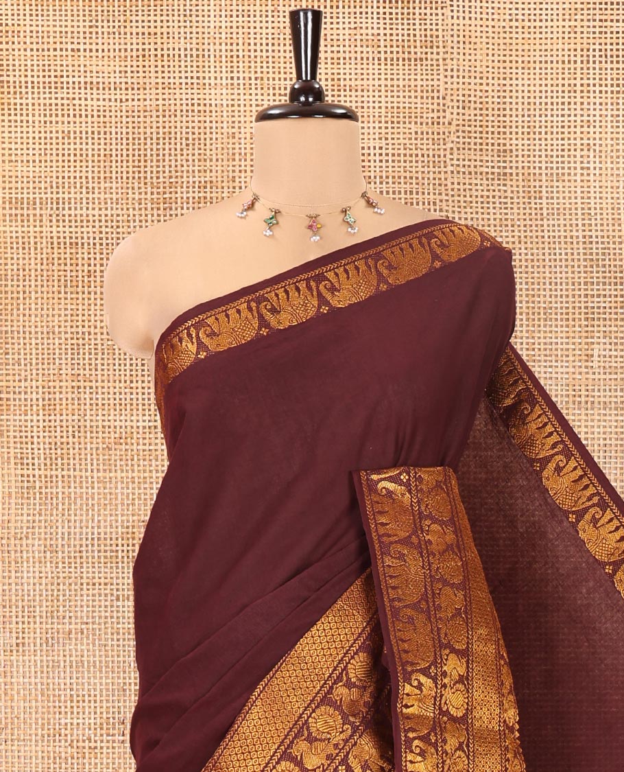 Coffee Brown Plain Sungudi Cotton Saree, Highlighted by Traditional Zari Border of Peacock and Elephant Motifs Weave, Subtly Striped Pallu, and Paired with a Contrast Veldhari Design Blouse