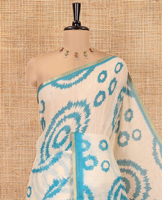 Cream-Blue  Linen Cotton Saree, Adorned with Shibori Print, Contrast Piping Border, Kalamkari Floral Vine Pallu, and a Contrast Blouse