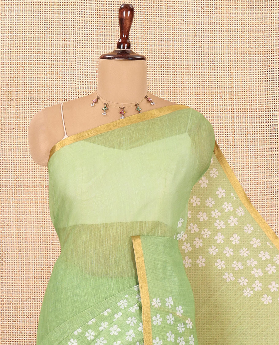 Green Linen Cotton Saree Features Half-And-Half-Style Flower Motifs Print, a Piping Border, and a Matching Blouse