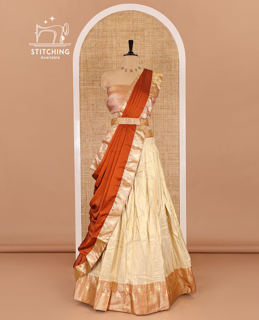 Chikku and rust half-saree, zari checked with contrast traditional zari bordered banarasi skirt, jacquard blouse, and a contrast zari bordered syska georgette dhavani