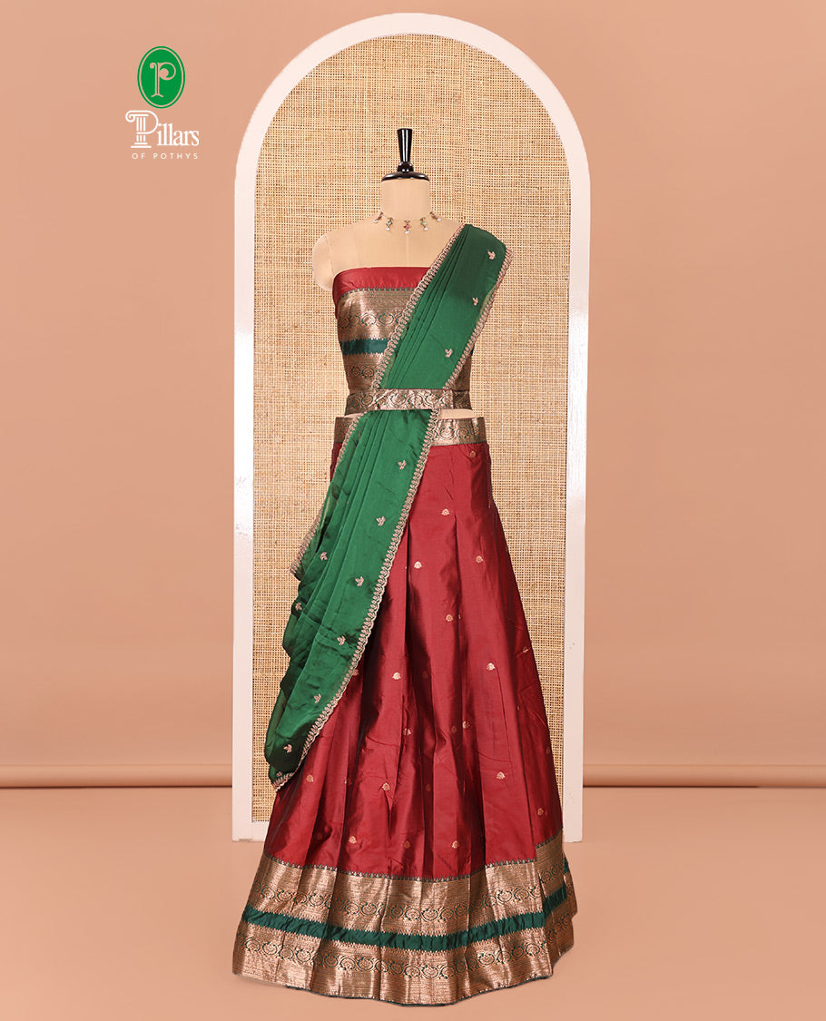 Maroon and Green Semi-Banarasi Half-Saree Featuring Zari Buttas Skirt, Complemented by Contrast Rettai Pettu, Traditional Border of Floral Creeper Designs, Paired with a Matching Blouse, and a Satin Georgette Embroidered Scallop Dhavani