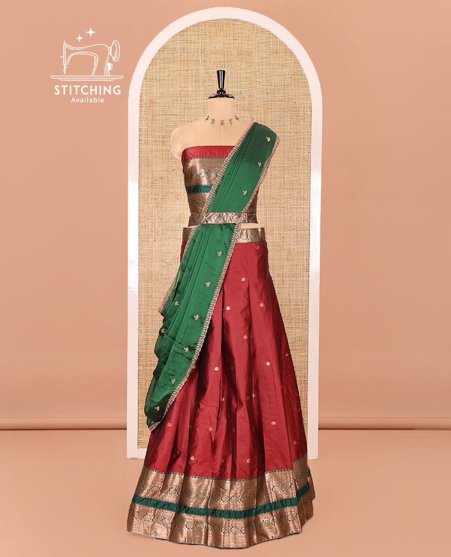 Maroon and Green Semi-Banarasi Half-Saree Featuring Zari Buttas Skirt, Complemented by Contrast Rettai Pettu, Traditional Border of Floral Creeper Designs, Paired with a Matching Blouse, and a Satin Georgette Embroidered Scallop Dhavani