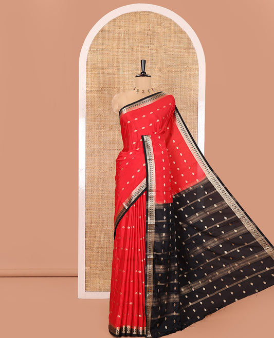 Red and Black Semi-Mysore Silk Saree, Adorned with Zari Buttas All Over Its Body, Complemented by a Contrast Traditional Zari Border of Paisleys, Pallu Steeped with Buttas, and Paired with a Contrast Blouse
