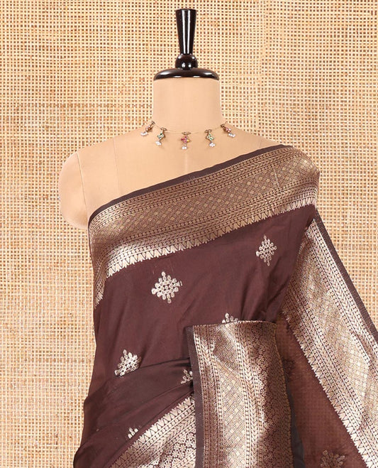 Coffee Brown Litchi Silk Saree, Mesmerized with Kolam Buttas All Over Its Body, Highlighted by a Traditional Zari Designs Woven Border, Grand Pallu of Intricate Designs, and Paired with a Matching Blouse