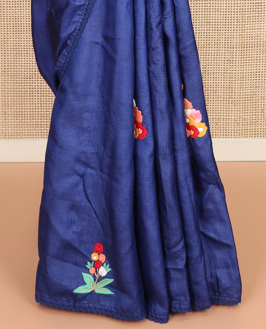 Borderless ink blue base tussar saree with kaleidoscopic-colored thread floral embroidery motifs