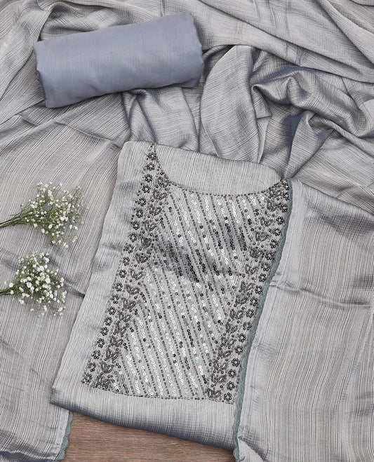Grey material chudidar set, neck embroidered top, plain bottom, and plain scallop border dupatta
