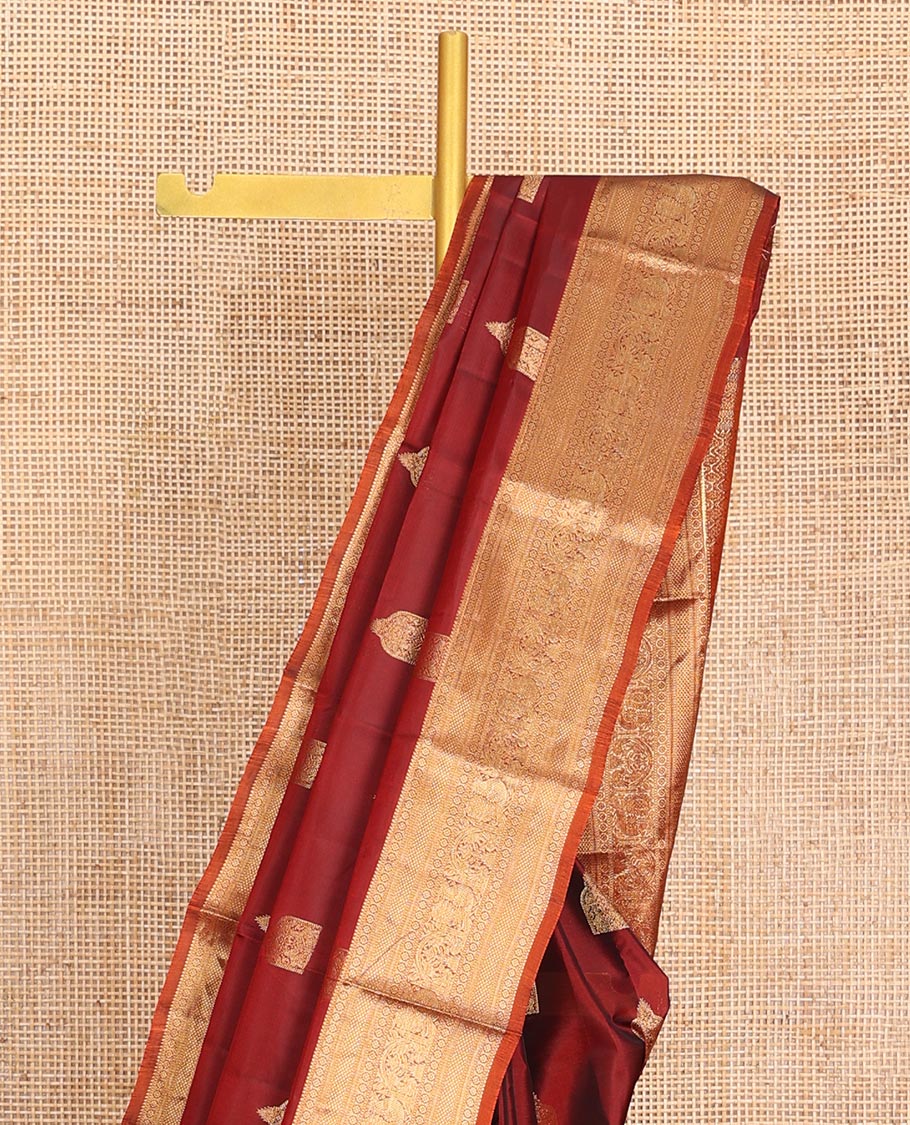 Maroon Vasundhara Lite-Silk Mix Saree, Detailed with Zari Buttas All Over Its Body, Highlighted by a Zari Border of Rekku, Kamalam, Kuyil Kann, Yaanai, and Mayil Designs, Grand Pallu of Jaal Designs, and Paired with a Contrast Blouse