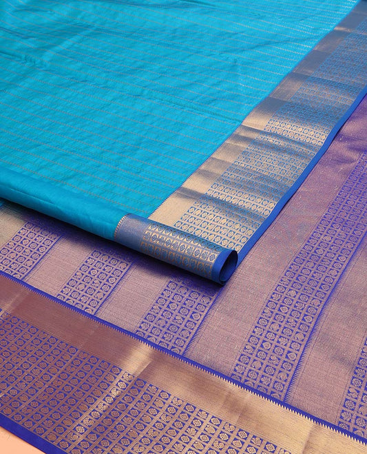 Blue Vasundhara Lite Silk Mix Saree Highlighted with Zig-Zag Stripes, Complemented with a Contrast Border Featuring Rekku, Annam, Chakram, and Manga Designs, Pallu Adorned with the Same Border Motifs, and Paired with a Contrast Blouse