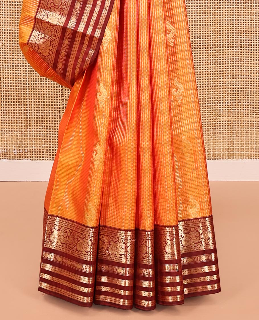 Orange Vasundhara Silk Saree, Masterfully Woven with Zari Buttas and Checks All Over Its Body, Complemented by a Contrast Border of Thilakam Mokku, Manga, Mayil, and Meen Designs, Grand Pallu, and Paired with a Contrast Blouse