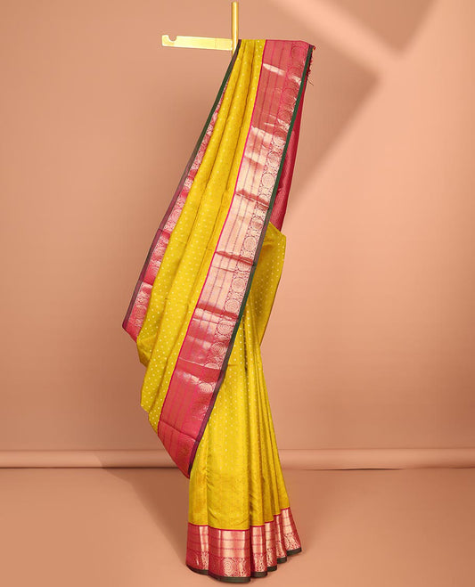 Yellow zari buttas silk saree, contrast border of Muthu,kathir & poo chakram designs & diagonal striped pallu