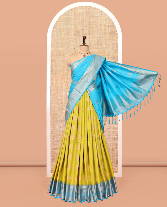 Green Art Silk Half-Saree Pavadai Material Features a Zari-Buttas Skirt, a Contrast Traditional Border, Contrast Blouse, and Intricate Dhavani