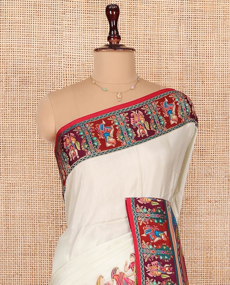 White Dola Silk Saree, Creatively Printed with Human Figurines on Its Body, Complemented by a Contrast Human Figurines Border, Pallu Depicts Colorful Human Figurines, and Paired with a Matching Blouse