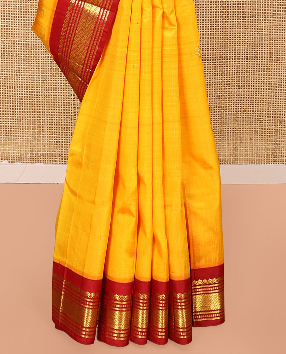 Yellow Kanchipuram Silk Saree, Woven with Zari Buttas All Over Its Body, Complemented by a Contrast One-Sided Korvai Border of Salngai, Banaras, Muthu, and Mayil Kann Designs, Pallu of Zari Designs, and Comes Without a Blouse