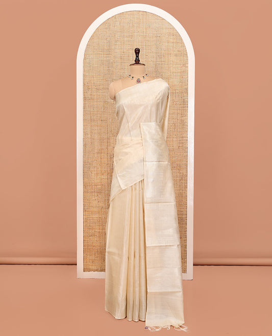 Cream Plain Tussar Silk Saree, a Gleaming Temple Zari Border, a Striped Pallu, and a Matching Blouse
