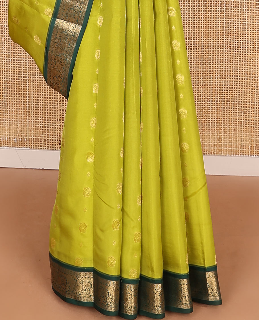 Green Vasundhara Lite-Silk Mix Saree Subtly Sparked with Zari Buttas, Complemented by a Contrast Border of Muthu, Rudraksham, and Mayil Designs, Pallu Elevated with Intricate Designs, and Paired with a Contrast Blouse