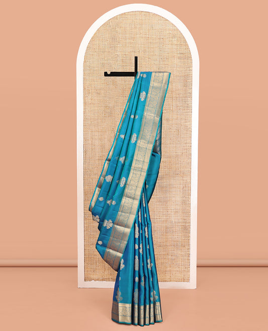 Blue Vasundhara Lite Silk Mix Saree, Elevated with Zari Buttas All Over Its Body, Highlighted by Zari Border of Thilakam Mokku, Mayil Kann, And Mayil Designs, Grand Pallu and Paired with a Matching Blouse