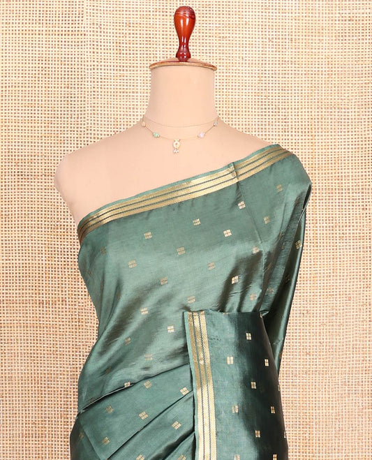 Green Banana Pith Saree Prettified with Square-Shaped Zari Buttas, Subtly Woven Zari Piping Border, Pallu Gleamed Up with Zari Stripes, and Paired with a Matching Blouse