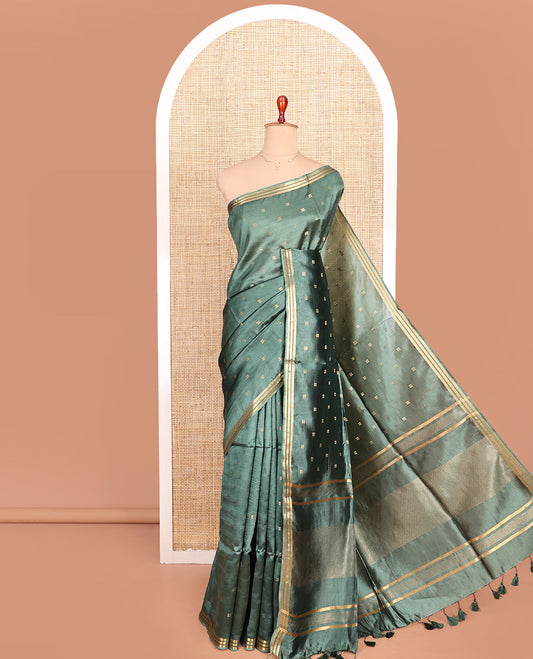Green Banana Pith Saree Prettified with Square-Shaped Zari Buttas, Subtly Woven Zari Piping Border, Pallu Gleamed Up with Zari Stripes, and Paired with a Matching Blouse