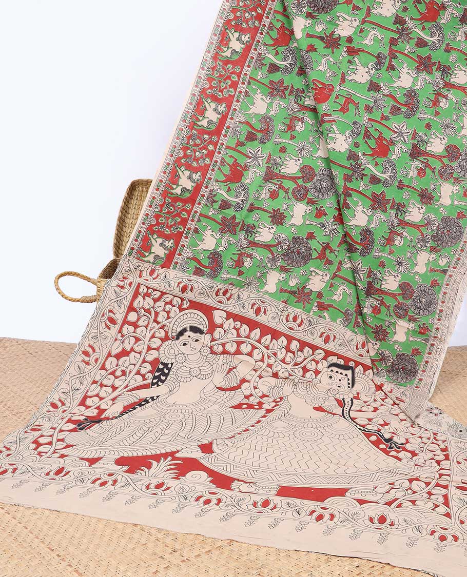 Green village-theme machine-printed kalamkari cotton saree,  contrast Pichwai cow border & human figurines pallu