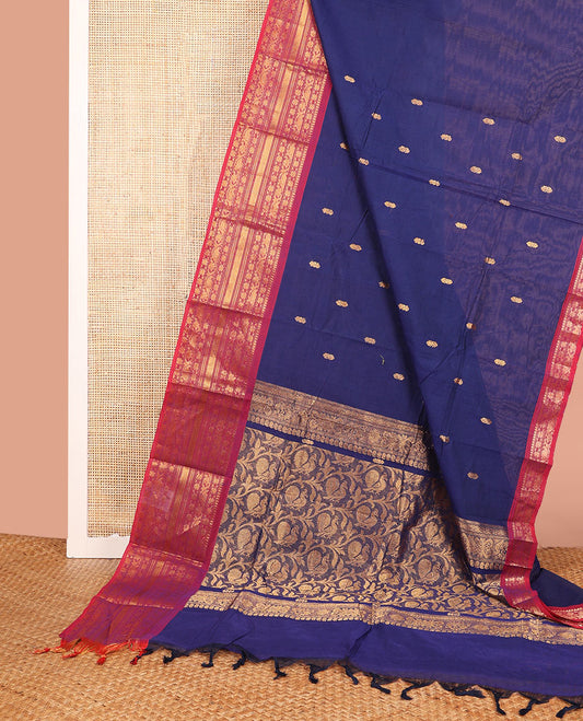 Blue Chettinad Cotton Saree Enriched with Zari Buttas All Over Its Body, Complemented by Contrast Border Steeped with Traditional Zari Designs, Pallu of Peacock and Floral Jaal Designs, and Paired with a Matching Blouse
