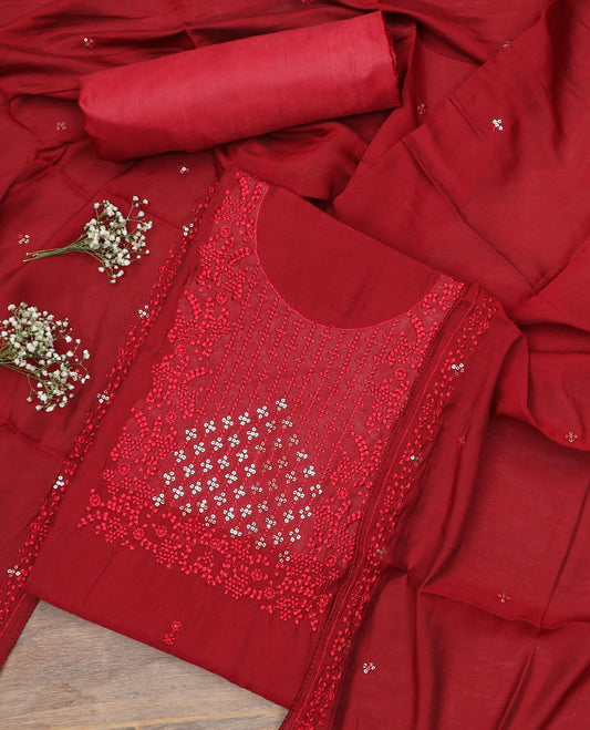 Red material chudidar set, sequins and thread neck embroidered top, plain bottom, and sequins and thread embroidered dupatta