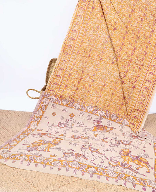Orange intricately machine-printed kalamkari cotton saree, contrast Pichwai cow & God Krishna motif pallu