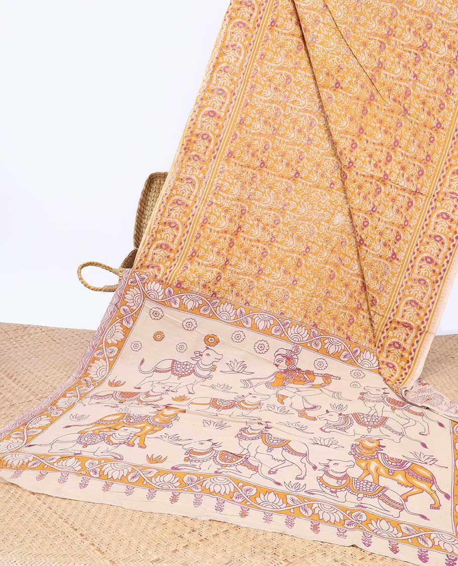 Orange intricately machine-printed kalamkari cotton saree, contrast Pichwai cow & God Krishna motif pallu