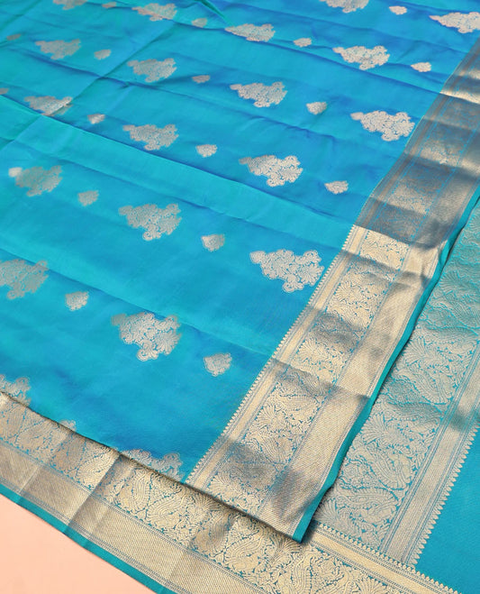 Blue Vasundhara Lite Silk Mix Saree, Elevated with Zari Buttas All Over Its Body, Highlighted by Zari Border of Thilakam Mokku, Mayil Kann, And Mayil Designs, Grand Pallu and Paired with a Matching Blouse