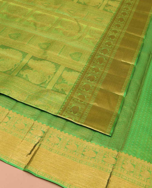 Green Kanchipuram Wedding Silk Saree, Entralled with Jacquard Design On Its Body, Highlighted by Zari Border of Rekku, Kathir, Muthu, Manga and Zari Stripes, Grand Pallu and Paired with a Matching Blouse