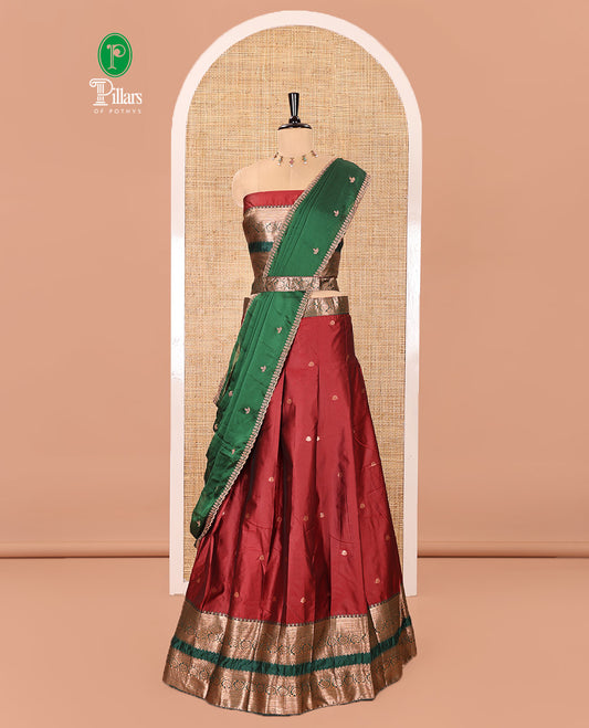 Maroon and Green Semi-Banarasi Half-Saree Featuring Zari Buttas Skirt, Complemented by Contrast Rettai Pettu, Traditional Border of Floral Creeper Designs, Paired with a Matching Blouse, and a Satin Georgette Embroidered Scallop Dhavani