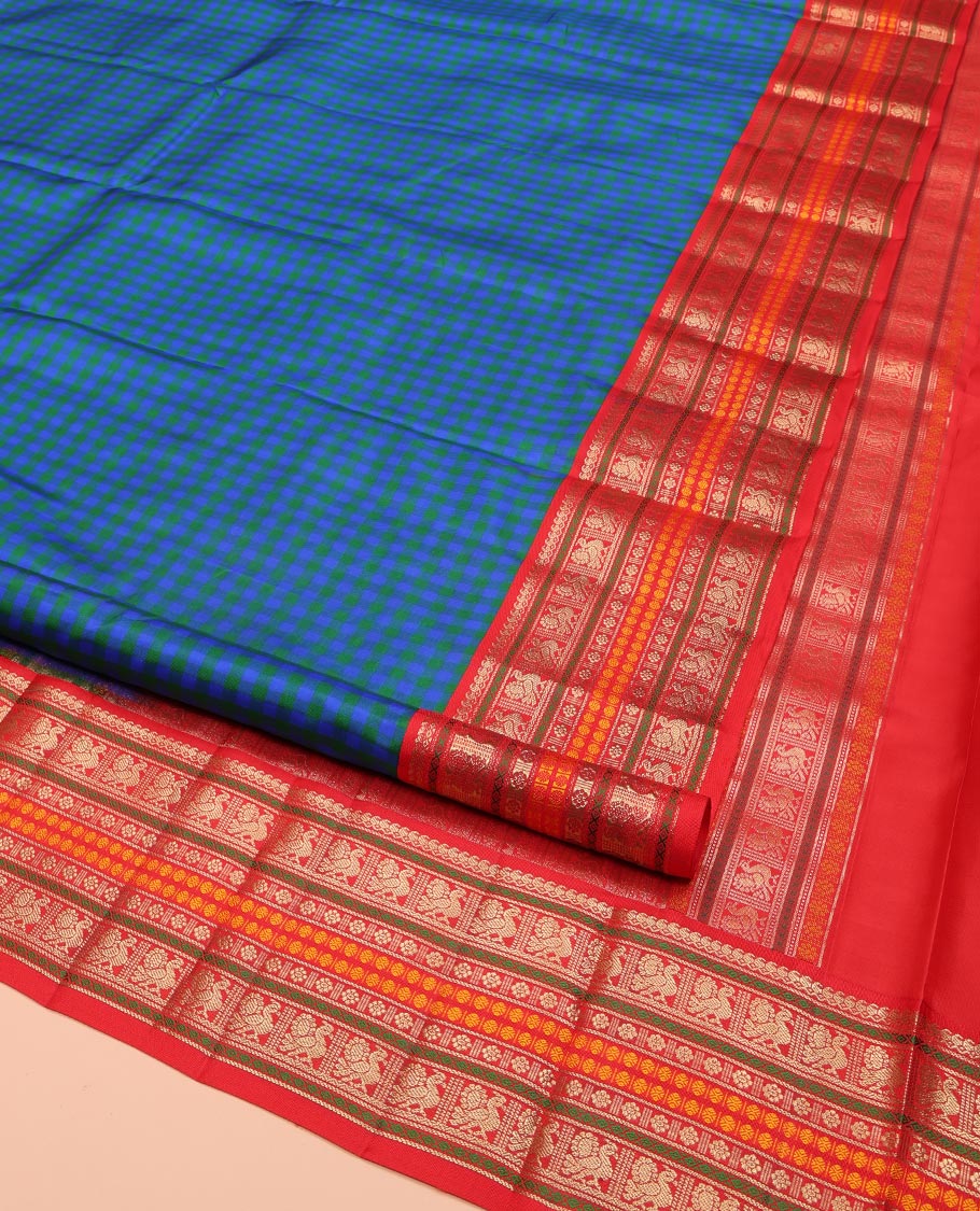 Blue and Green Kanchipuram Silk Saree, Decked Up with Checked Design on Its Body, Complemented by a Contrast Border of Thilakam Mokku, Mayil, Laddu Kamalam, and Rudraksham Designs, Pallu Steeped with Traditional Designs, and Paired with a Contrast Blouse