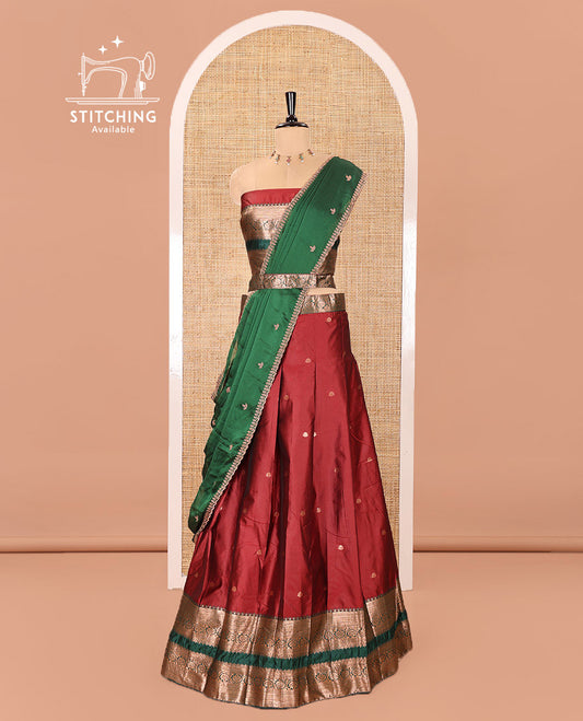 Maroon and Green Semi-Banarasi Half-Saree Featuring Zari Buttas Skirt, Complemented by Contrast Rettai Pettu, Traditional Border of Floral Creeper Designs, Paired with a Matching Blouse, and a Satin Georgette Embroidered Scallop Dhavani