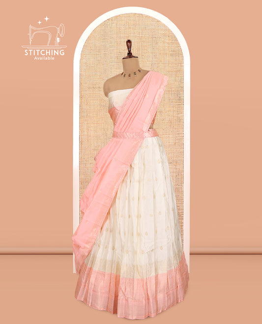 Cream-Peach Semi-Silk Half-Saree, Subtly Sparkled with Zari Buttas Skirt, a Contrast Traditional Zari Border, and a Contrast Dhavani