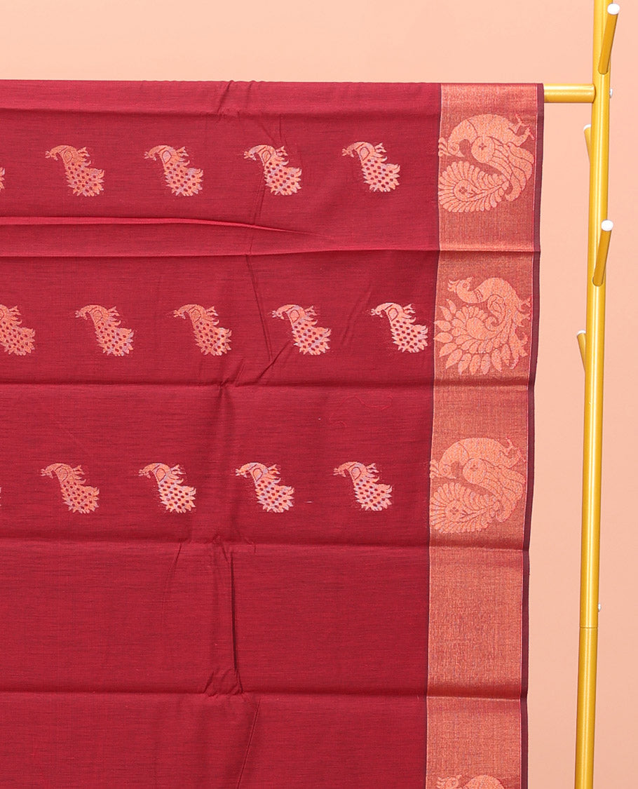 Maroon Semi-Silk Cotton Saree, Ornamented with Peacock Buttas All Over Its Body, Highlighted by a Zari Border of Peacock Designs, Pallu Steeped with Peacock Zari Motifs, and Paired with a Matching Blouse