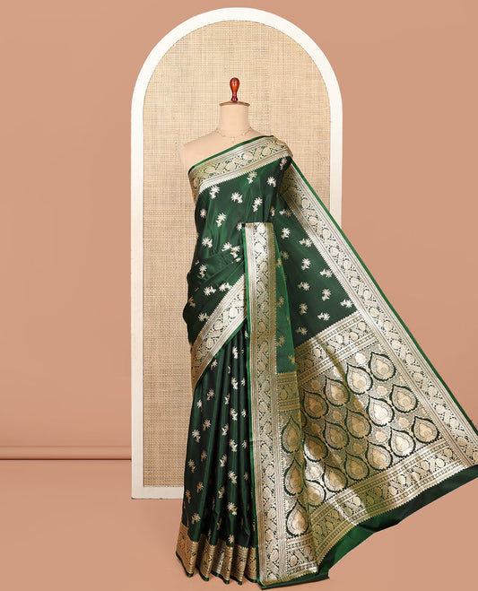 Green Semi-Banaras Saree, Spotlighted with Floral Buttas on Its Body, Highlighted by a Floral Creeper Border, Intricately Designed Pallu, and Paired with a Matching Blouse