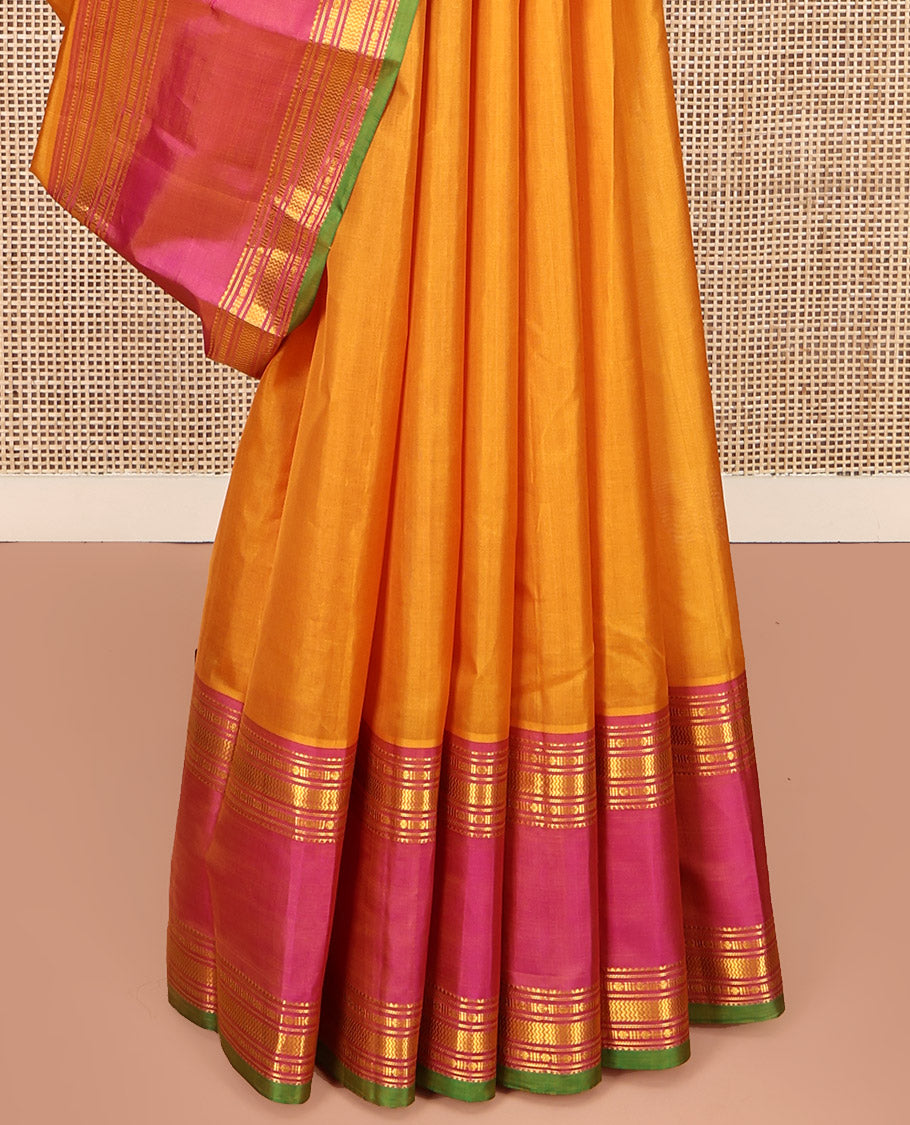 Orange Plain Kanchipuram Silk Saree, Complemented by Contrast Rettai Pettu Border of Rekku, Rudraksham, and Vanki Designs, Pallu of Traditional Zari Designs, and Paired with a Contrast Blouse