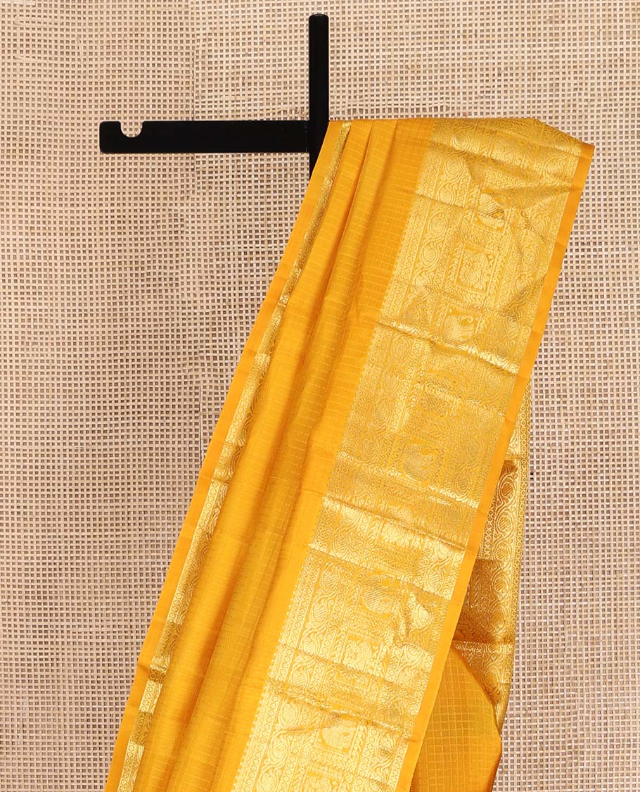 Yellow Kanchipuram Silk Saree, Sparsely Woven with Checked Design All Over Its Body, Highlighted by a Zari Border of Manga, Yaanai, and Mayil Designs, Pallu of Jaal Designs, and Paired with a Matching Blouse