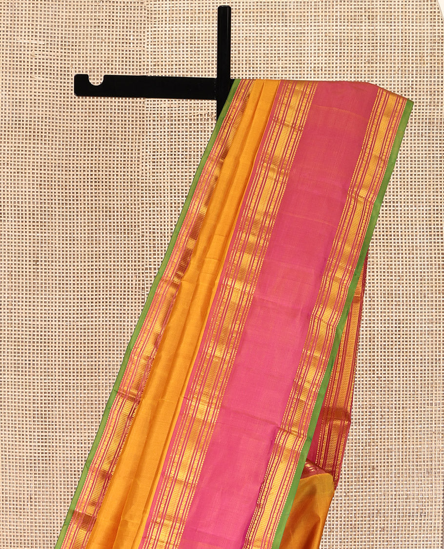 Orange Plain Kanchipuram Silk Saree, Complemented by Contrast Rettai Pettu Border of Rekku, Rudraksham, and Vanki Designs, Pallu of Traditional Zari Designs, and Paired with a Contrast Blouse