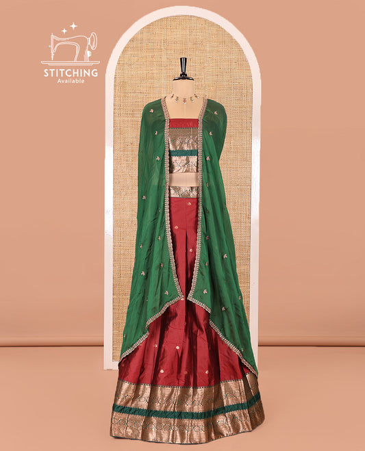 Maroon and Green Semi-Banarasi Half-Saree Featuring Zari Buttas Skirt, Complemented by Contrast Rettai Pettu, Traditional Border of Floral Creeper Designs, Paired with a Matching Blouse, and a Satin Georgette Embroidered Scallop Dhavani