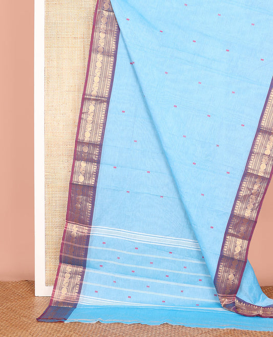 Blue Chettinad Cotton Saree Decked up with Buttas All Over Its Body, Complemented by a Contrast Border of Traditional Zari Designs, and Pallu Features Stripes and Buttas