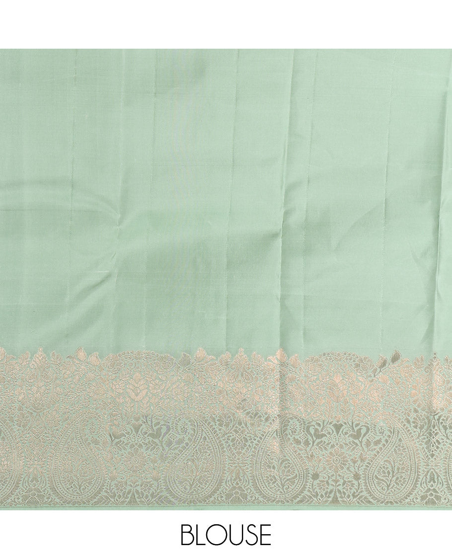 Green Kanchipuram Silk Saree, Delicately Woven with Zari Buttas All Over Its Body, Highlighted by a Zari Border of Floral and Paisley Designs, Grand Chevron Striped Pallu, and Paired with a Matching Blouse