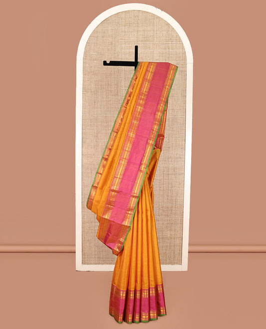 Orange Plain Kanchipuram Silk Saree, Complemented by Contrast Rettai Pettu Border of Rekku, Rudraksham, and Vanki Designs, Pallu of Traditional Zari Designs, and Paired with a Contrast Blouse