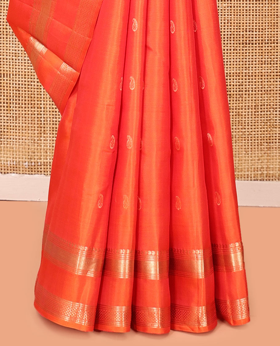 Orange Kanchipuram Silk Saree, Ornamented with Manga Buttas, Highlighted By Zari Rettai Pettu Border of Manga, Banaras, Mayil Kann, and Arai Maadam Design, Grand Pallu, and a Matching Blouse