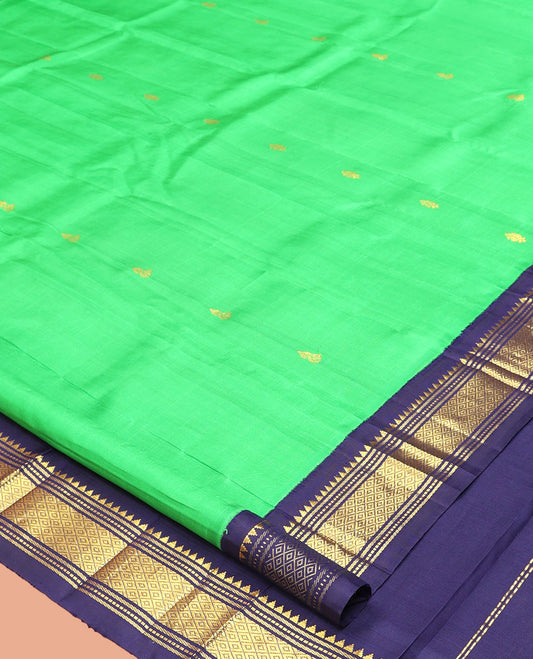 Green Kanchipuram Silk Saree, Accentuated with Zari Buttas, a Contrast One-Sided Korvai Border of Rekku, Banaras, Muthu, and Mayil Kann Designs, a Zari Design Pallu, and No Blouse