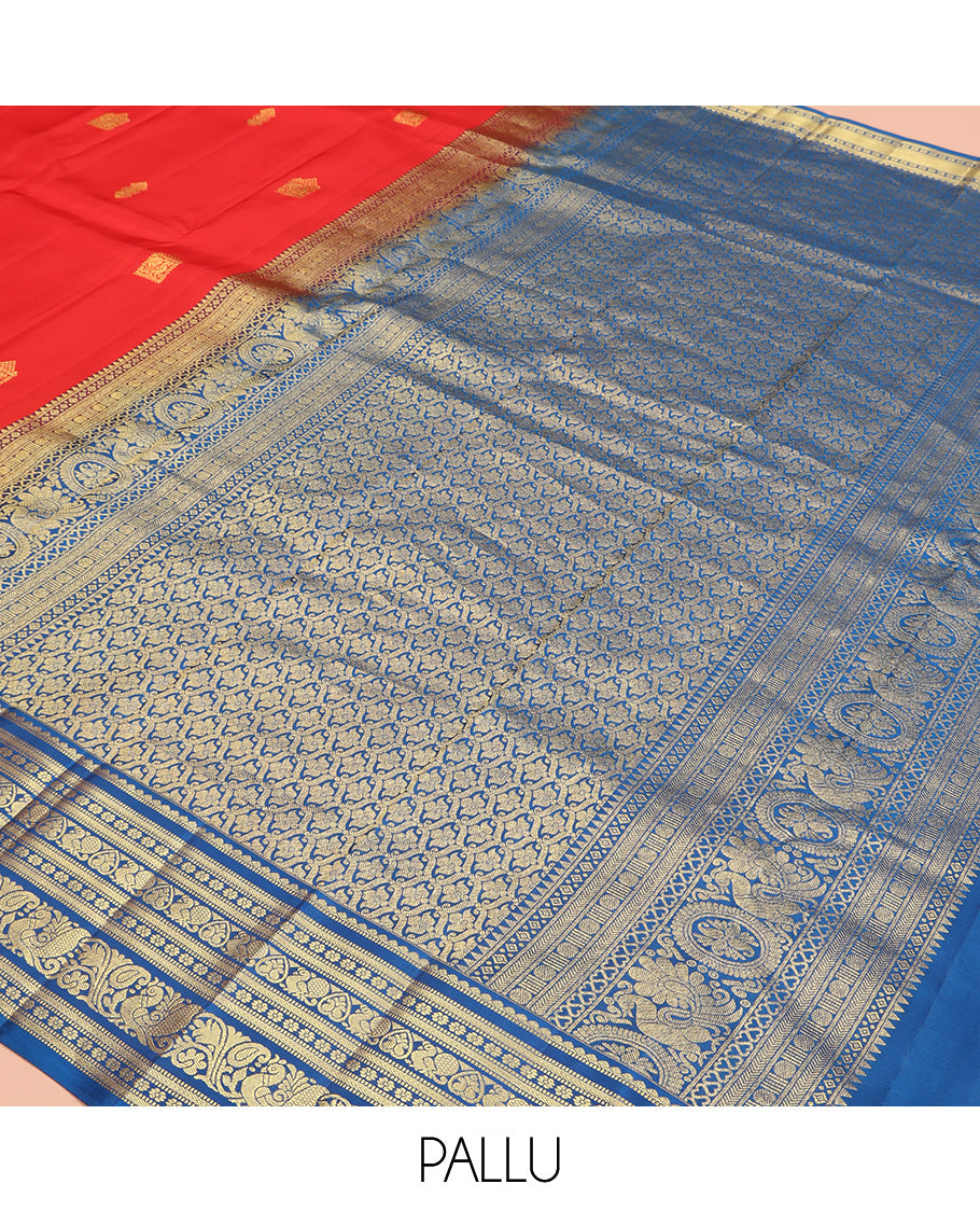 Orange Vasundhara Silk Saree, Subtly Sparkled With Zari Buttas All Over Its Body, Complemented by Contrast Border of Salngai, Muthu, Kamalam, Jada Nagam, and Mayil Designs, Grand Pallu and Paired with a Contrast Blouse