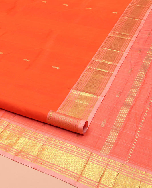 Orange Kanchipuram Silk Saree, Mesmerized with Zari Buttas on Its Body, Complemented by a Contrast One-Sided Border of Paneer Sombu, Banaras, Muthu and Mayil Kann Designs, Pallu of Zari Designs, and Comes Without a Blouse