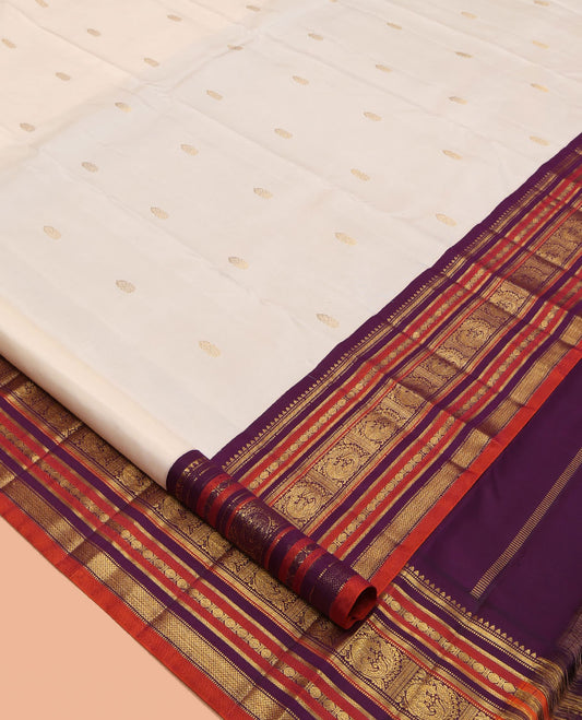 White Kanchipuram Silk Saree, Enthralled with Zari Buttas, a Contrast Korvai Border of Rekku, Muthu, Banaras, Poun, Mayil, Kathir, and Mayil Kann, Grand Pallu, and a Contrast Blouse