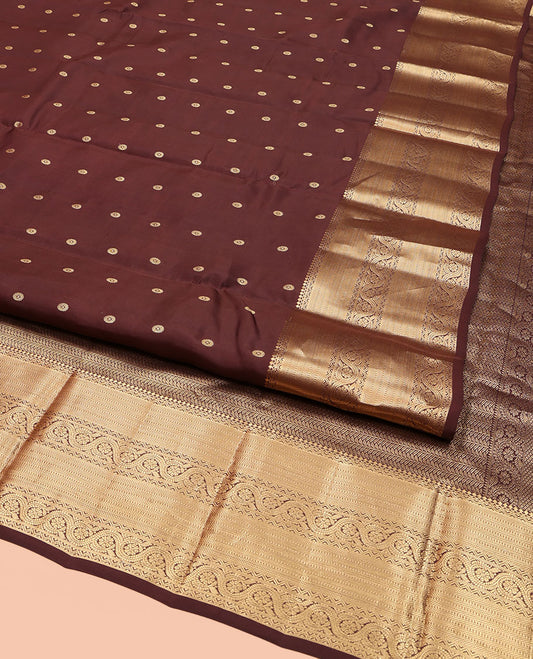 Brown Vasundhara Lite Silk Mix Saree, Decked Up with Zari Buttas All Over Its Body, Highlighted by a Zari Border of Salngai, Muthu, Dhavana Kodi, and Mayil Kann Designs, Pallu of Leaf Vine Designs, and Paired with a Matching Blouse